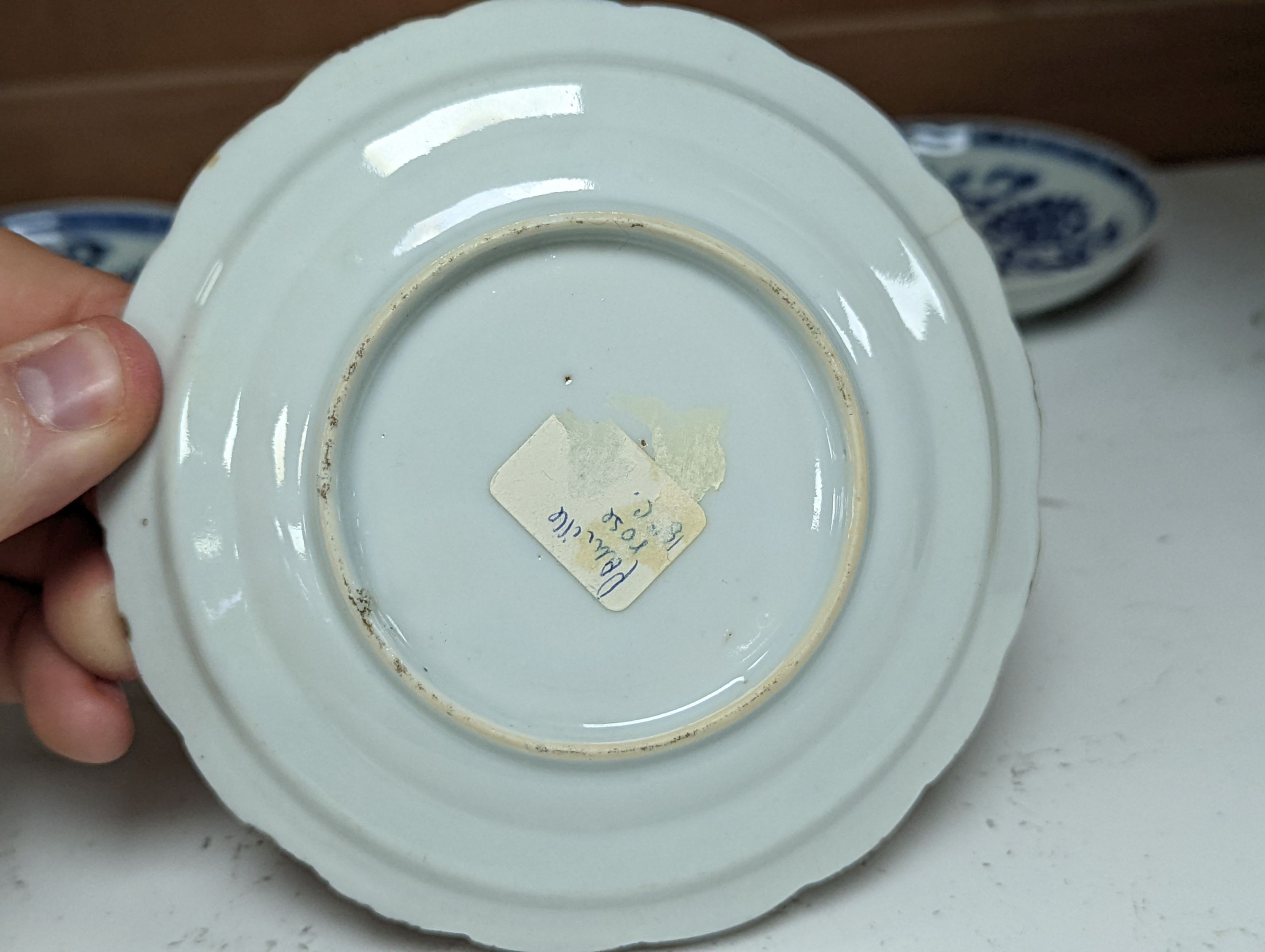 Seven 18th century Chinese saucer dishes, largest 14 cms diameter.